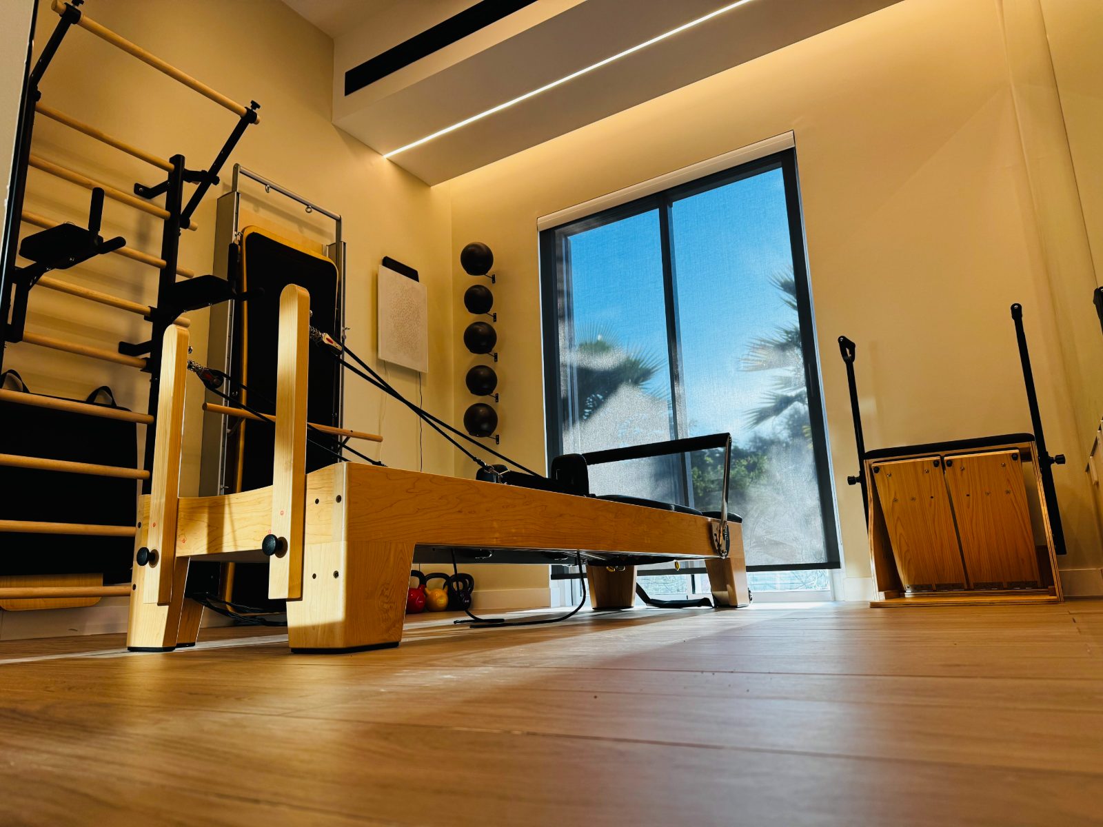 Inside the formadxb studio — reformer, wall unit and a sunlit window